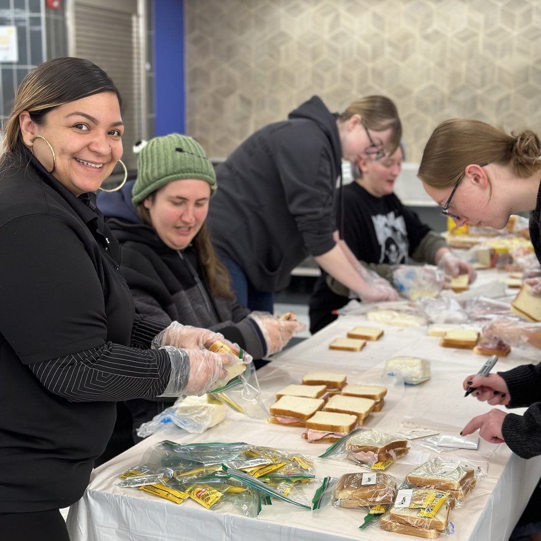 Camden Healthy Start team members and volunteers making sandwiches together at an MLK Day 2024 event